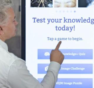 A man and woman at touchscreen kiosk